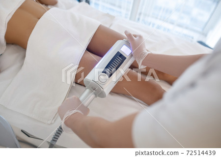 Doctors hands with apparatus performing the procedure 72514439