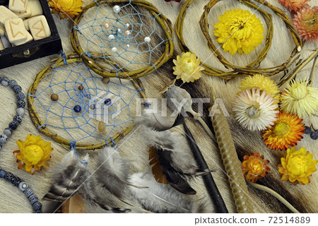 Still life with dreamcatchers, candles, runes, yellow flowers and ritual magic objects on witch table. Esoteric, gothic and occult background, Halloween mystic concept. Still life with dreamcatchers, candles, runes, yellow flowers and ritual magic objects on witch table. Esoteric, gothic and occult background, Halloween mystic concept. 72514889