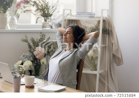 Calm happy woman flower shop consultant relaxing with closed eyes Calm happy woman flower shop consultant relaxing with closed eyes 72515884