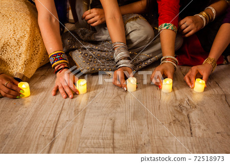 Lighting candles and oil lamps as part of Diwali traditions 72518973