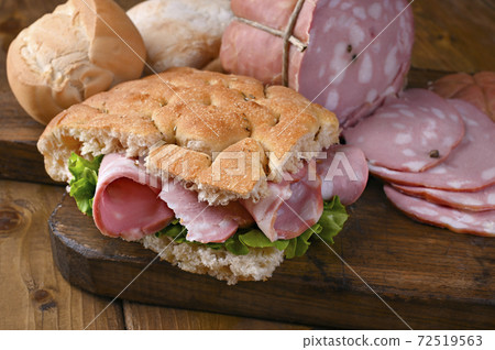 Traditional Italian antipasti mortadella on a wooden plate 72519563