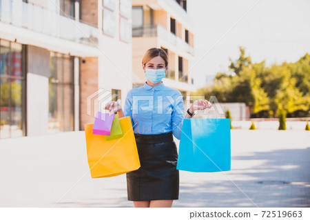 The woman is shopping in new conditions during coronavirus epidemic The woman is shopping in new conditions during coronavirus epidemic 72519663