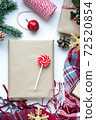 Present in brown craft paper, boxes, candy, plaid and Christmas decoration on table. Copy space. Eco friendly New Year 72520854