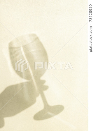 Shadow of a hand holding a wine glass 72520930