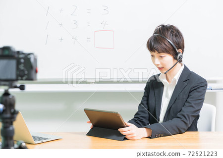 Young female teacher giving online lessons 72521223