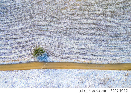 Windy winter road in snow covered forest, top down aerial view. Windy winter road in snow covered forest, top down aerial view. 72521662