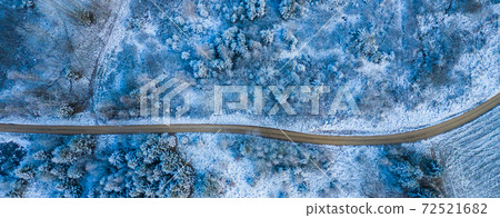 Windy winter road in snow covered forest, top down aerial view. Windy winter road in snow covered forest, top down aerial view. 72521682