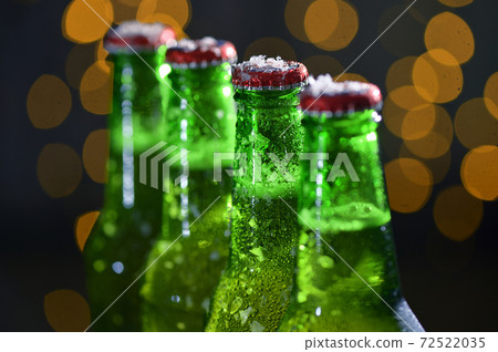 Green Bottle Of Beer and Holiday Glitter Background 72522035