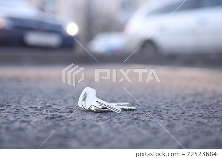 Bunch of keys lies on road in parking lot Bunch of keys lies on road in parking lot 72523684