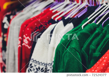 Colorful collection of women's clothes hanging on a rack. Colorful collection of women's clothes hanging on a rack. 72524377