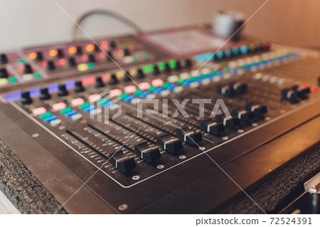 Part of an audio sound mixer with buttons. 72524391