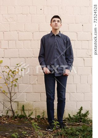 sad teenager boy full body photo on white wall background 72524528