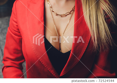 Woman in a red jacket revealing a black bra. Woman in a red jacket revealing a black bra. 72524544