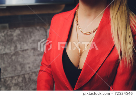 Woman in a red jacket revealing a black bra. Woman in a red jacket revealing a black bra. 72524546
