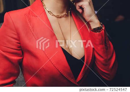Woman in a red jacket revealing a black bra. Woman in a red jacket revealing a black bra. 72524547