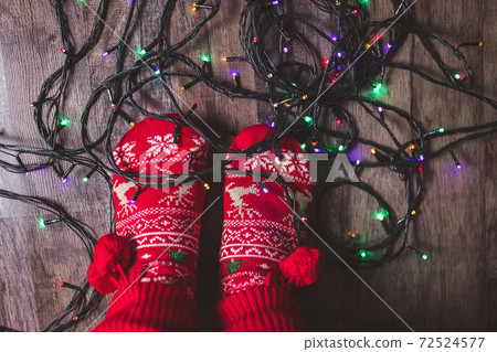 Tangled Christmas lights at feet on floor Tangled Christmas lights at feet on floor 72524577