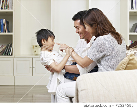 asian parents and son having fun at home 72524593