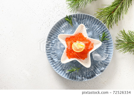 Red caviar in bowl in shape of star on white Red caviar in bowl in shape of star on white 72526334