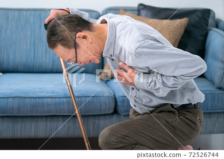 Senior man who collapses in the living room Senior man who collapses in the living room 72526744