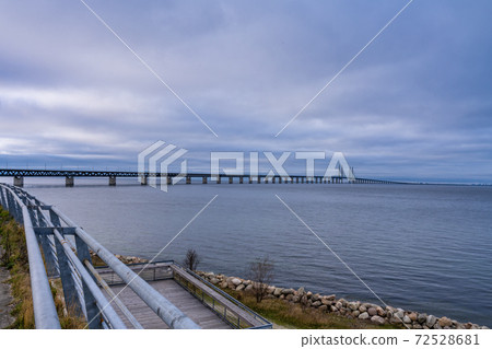 The Oresund Bridge, the bridge and underwater tunnel connecting Malmo, Sweden with Copenhagen, Denmark. A beautiful sunset sky in the background The Oresund Bridge, the bridge and underwater tunnel connecting Malmo, Sweden with Copenhagen, Denmark. A beautiful sunset sky in the background 72528681