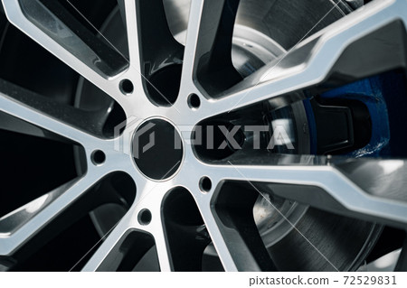 Aluminium rim of luxury car wheel close up Aluminium rim of luxury car wheel close up 72529831