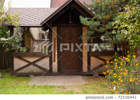 summer house on a green lawn among the trees 72530441