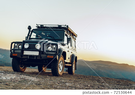 Dark green off-road car in the mountains Dark green off-road car in the mountains 72530644