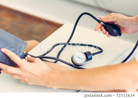 Measurement of heart and blood pressure using a tonometer, patient and doctor. Measurement of heart and blood pressure using a tonometer, patient and doctor. 72531624