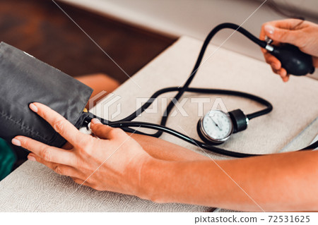 Measurement of heart and blood pressure using a tonometer, patient and doctor. Measurement of heart and blood pressure using a tonometer, patient and doctor. 72531625