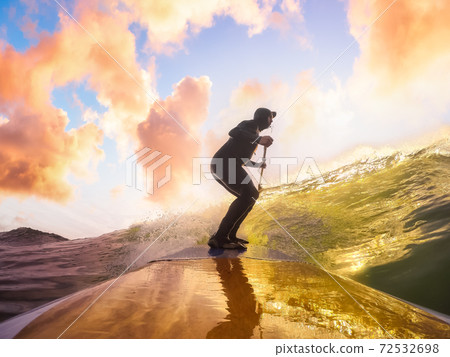 Adventurous Man Surfing the waves at the Pacific Ocean Adventurous Man Surfing the waves at the Pacific Ocean 72532698