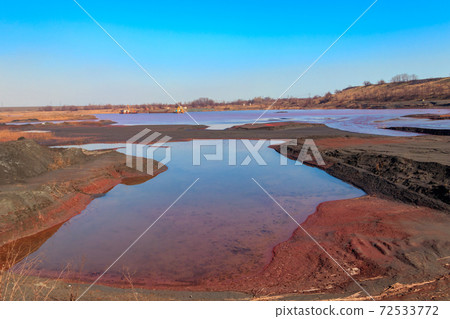 Technical settler of industrial water of mining industry in Kryvyi Rih, Ukraine. Red water polluted with iron ore waste 72533772