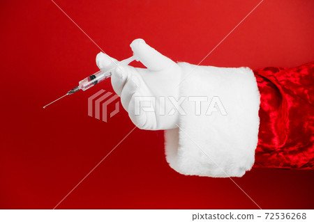 Santa hand with syringe, medical injection. Medicine equipment with needle. Liquid drug or drug. Hospital medical care. Corona virus vaccine, covid -19 vaccination. Santa hand with syringe, medical injection. Medicine equipment with needle. Liquid drug or drug. Hospital medical care. Corona virus vaccine, covid -19 vaccination. 72536268