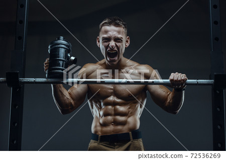 Bodybuilder drinking water after fitness workout Bodybuilder drinking water after fitness workout 72536269