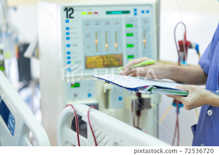 The specialist are checking continuous renal replacement therapy equipment and injection pump and hemodialysis machine. 72536720