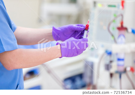 The specialist are checking continuous renal replacement therapy equipment and injection pump and hemodialysis machine. The specialist are checking continuous renal replacement therapy equipment and injection pump and hemodialysis machine. 72536734