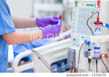 The specialist are checking continuous renal replacement therapy equipment and injection pump and hemodialysis machine. The specialist are checking continuous renal replacement therapy equipment and injection pump and hemodialysis machine. 72536735