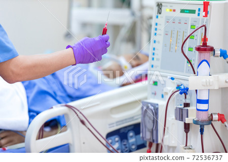 The specialist are checking continuous renal replacement therapy equipment and injection pump and hemodialysis machine. The specialist are checking continuous renal replacement therapy equipment and injection pump and hemodialysis machine. 72536737