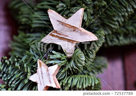 Fir branch christmasdecoration with two small stars of birch as a close up Fir branch christmasdecoration with two small stars of birch as a close up 72537789