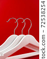 White hangers on a red background. Sales clothes concept. 72538254