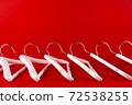 White hangers on a red background. Sales clothes concept. 72538255
