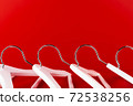 White hangers on a red background. Sales clothes concept. 72538256