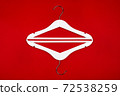 White hangers on a red background. Sales clothes concept. 72538259