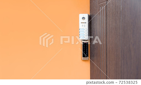 intercom with doorbell buttons and video call and card reader for an electronic access key on the wall at the entrance doors outside, close-up of electronic security devices with copy space. intercom with doorbell buttons and video call and card reader for an electronic access key on the wall at the entrance doors outside, close-up of electronic security devices with copy space. 72538325