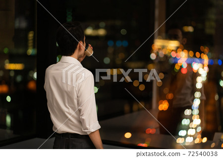 A businessman who works overtime late at night in the office A businessman who works overtime late at night in the office 72540038