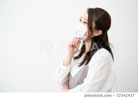 Profile of a woman wearing a mask 72542437