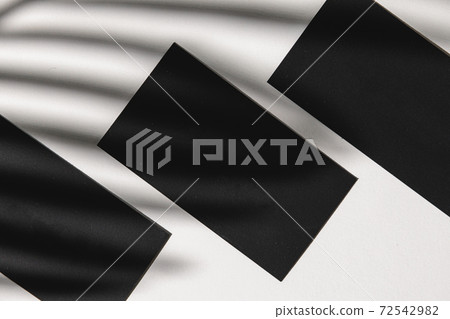 Business card on paper background with foliage shadow 72542982