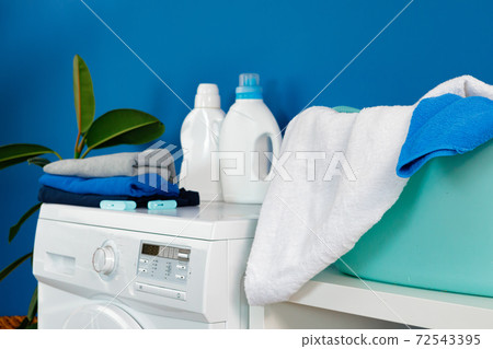 Bottle of detergent whith washing machine, indoors 72543395