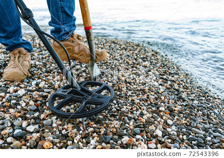 Metal detector coil in action above the ground 72543396