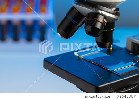 Close up photo of a microscope lenses examining glass sample Close up photo of a microscope lenses examining glass sample 72543397