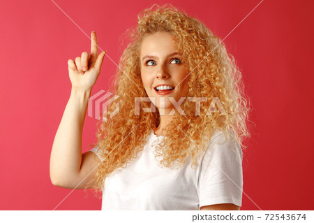 Young attractive blonde woman pointing her finger to copy space Young attractive blonde woman pointing her finger to copy space 72543674